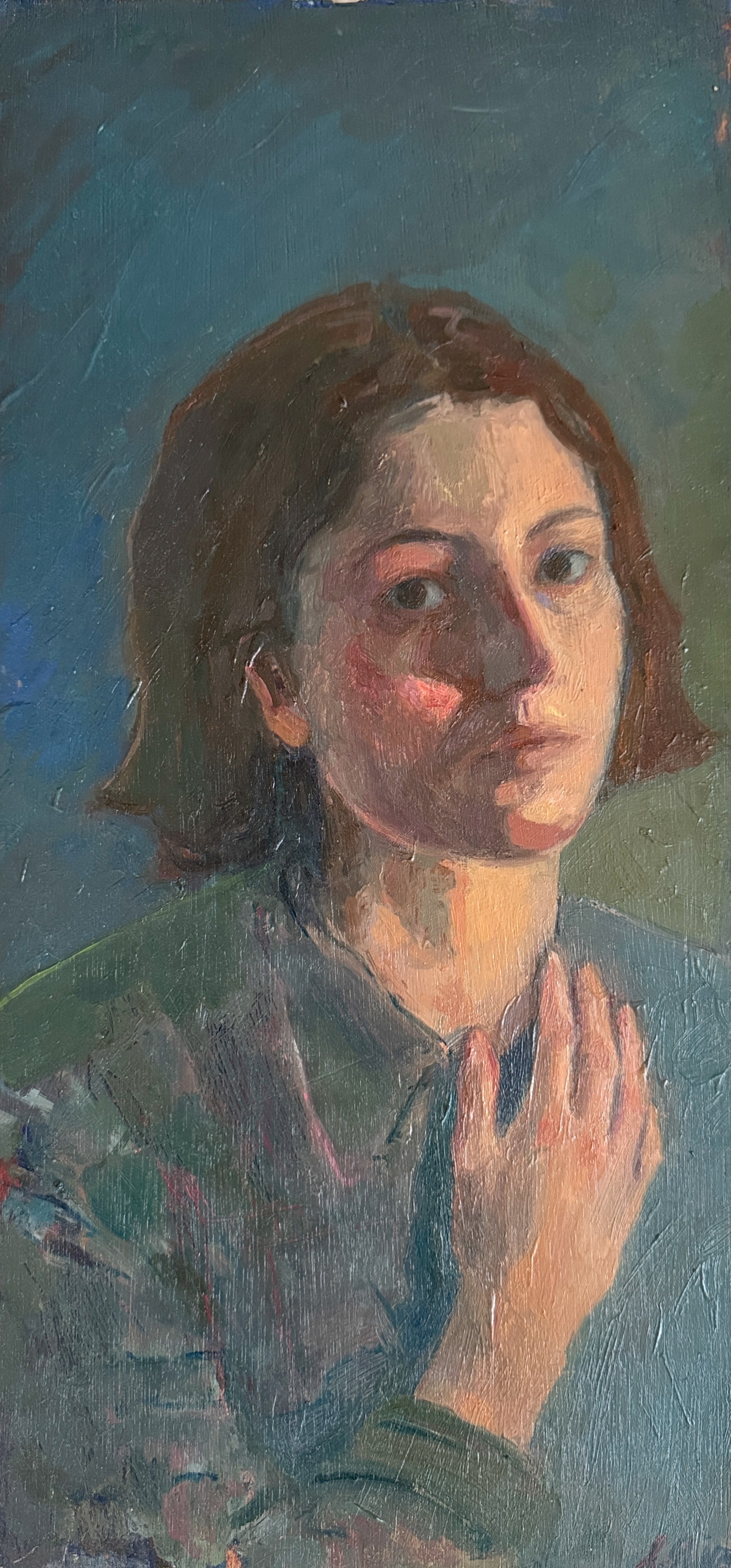 A girl with her hand on her chest looks directly at the viewer.